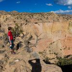 child wearing red shirt looking at canyon