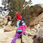 children hiking and climbing on rocks