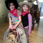 cowboy and cowgirl sitting on a saddle
