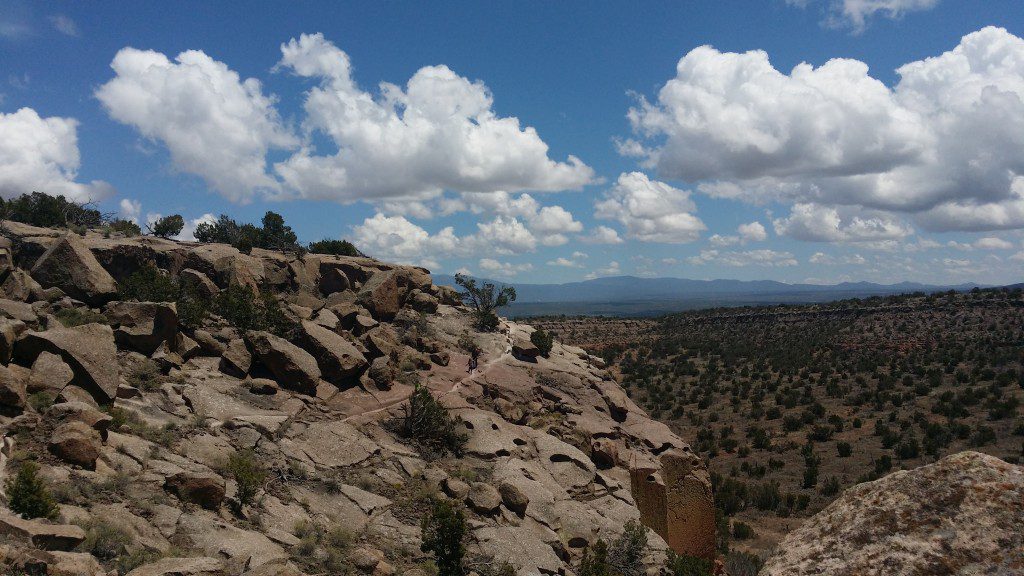 rock formations and hiking trail with blue sky and clouds
