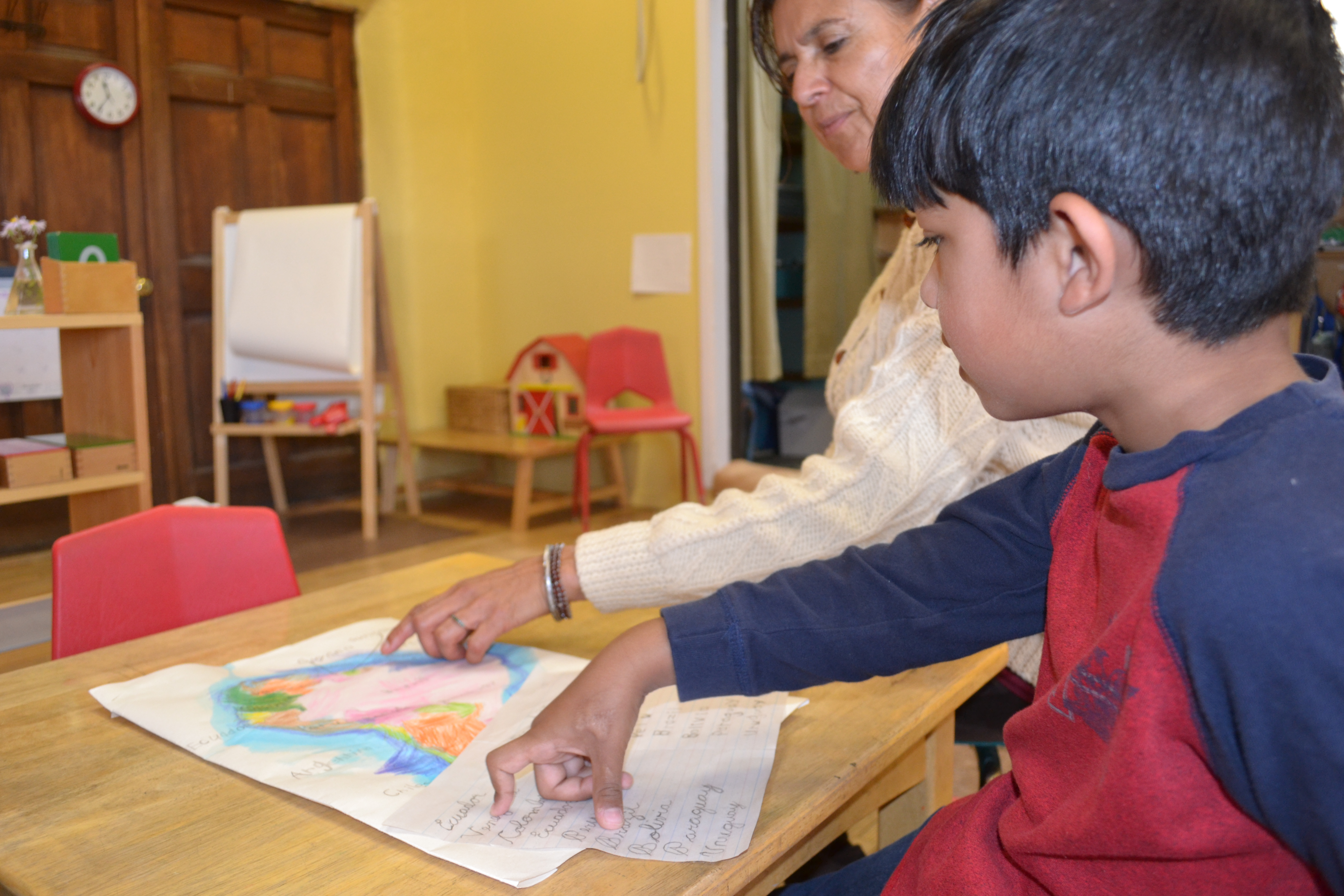 a man and a little boy pointing to a painting